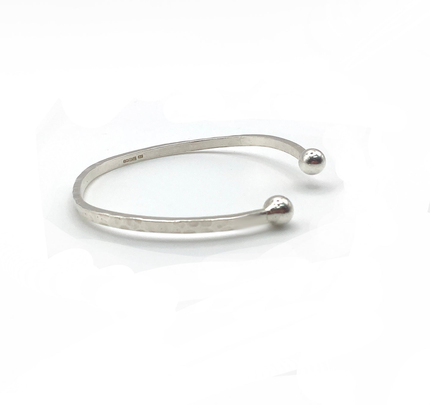 Sterling silver battered bangle with two balls